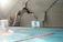 Young athlete diving into the pool during a water polo practice session.