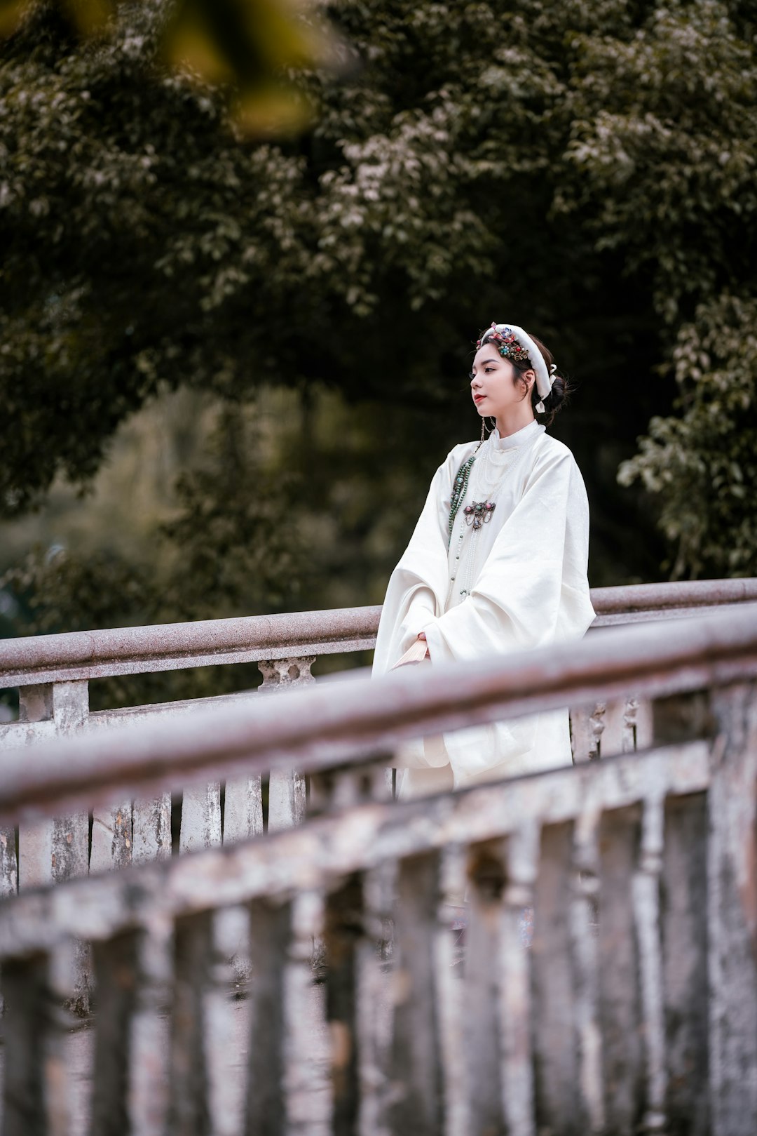 woman in white long sleeve shirt standing beside brown wooden fence during daytime