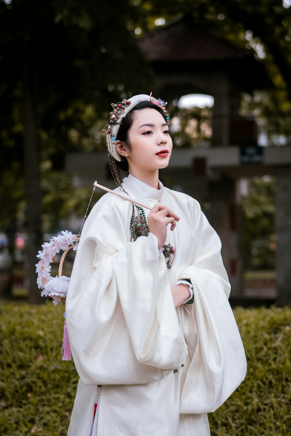 woman in white long sleeve dress holding bouquet of flowers