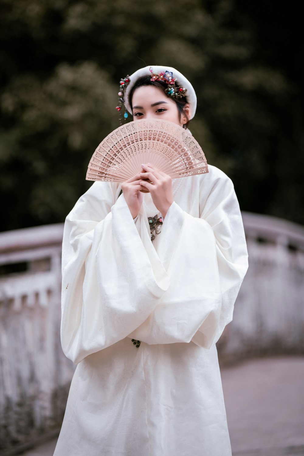 woman in white long sleeve shirt wearing white and red floral hat