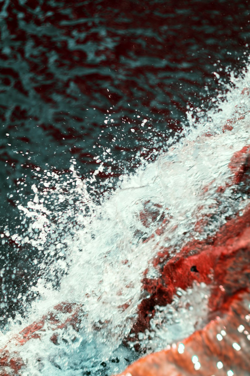 water waves on red concrete wall