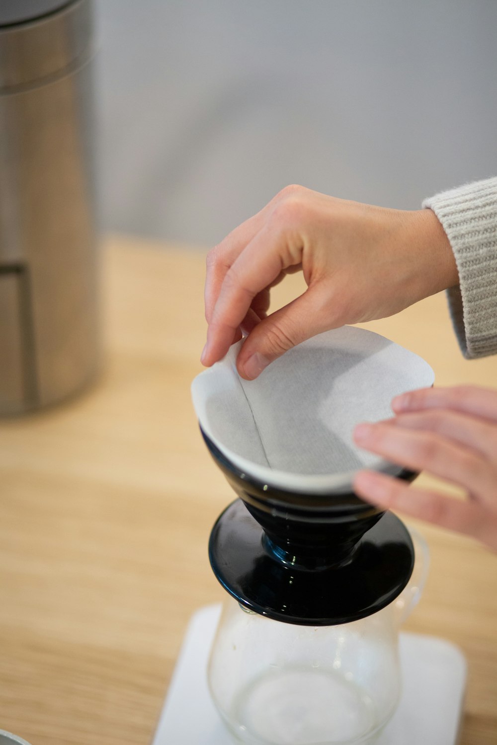 person holding white ceramic cup on black saucer