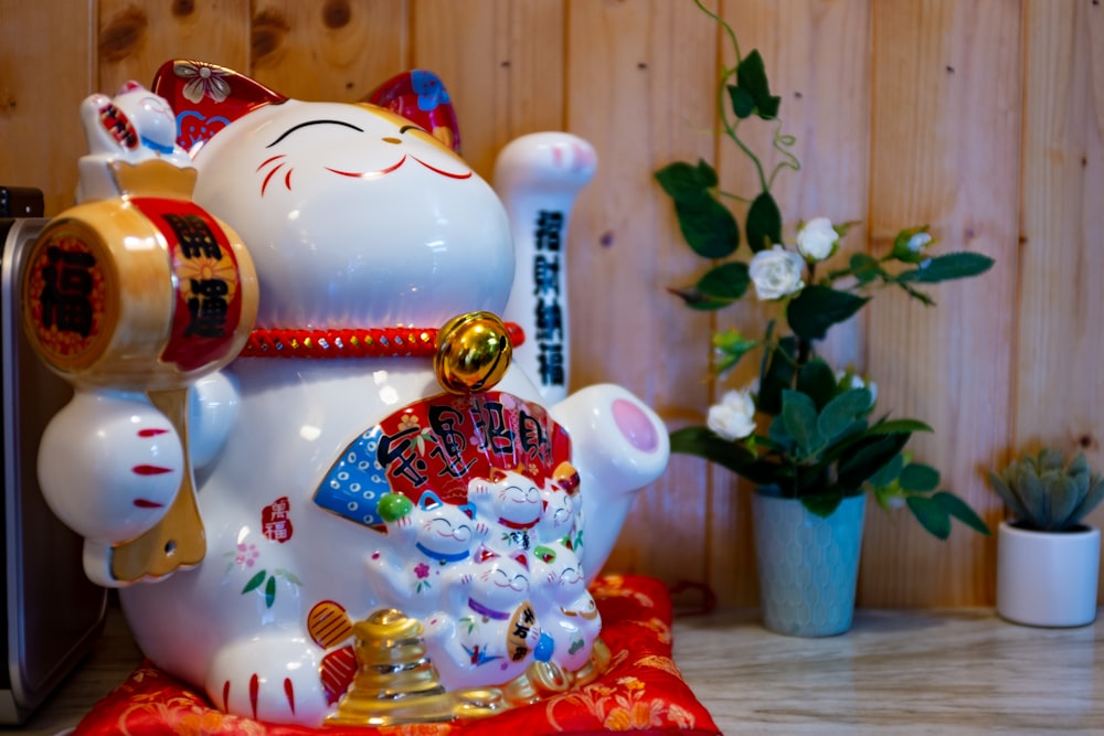 red and white ceramic cat figurine