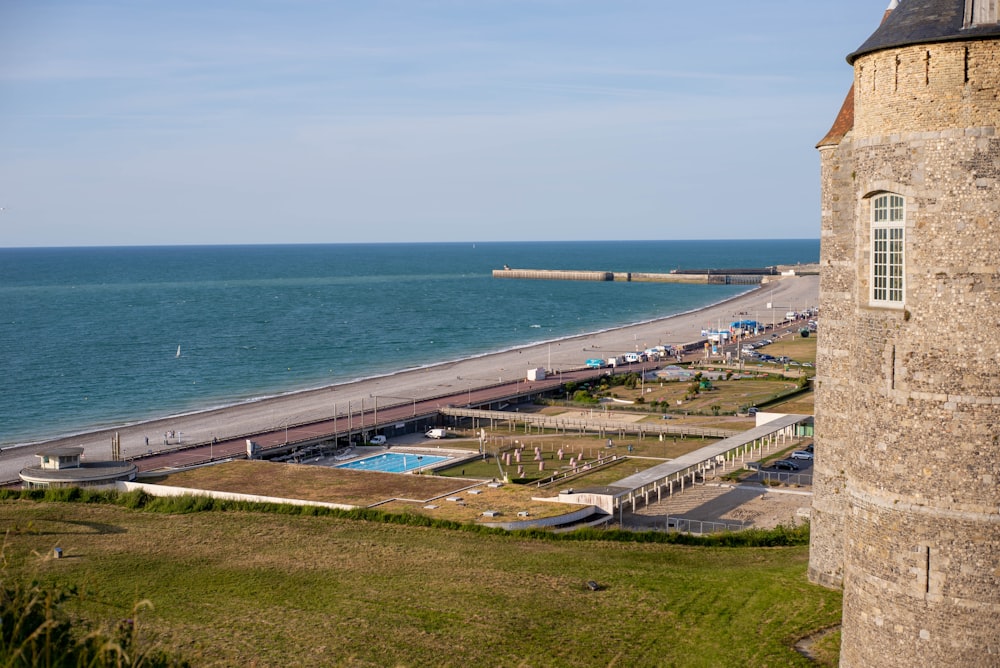 brown concrete building near sea during daytime