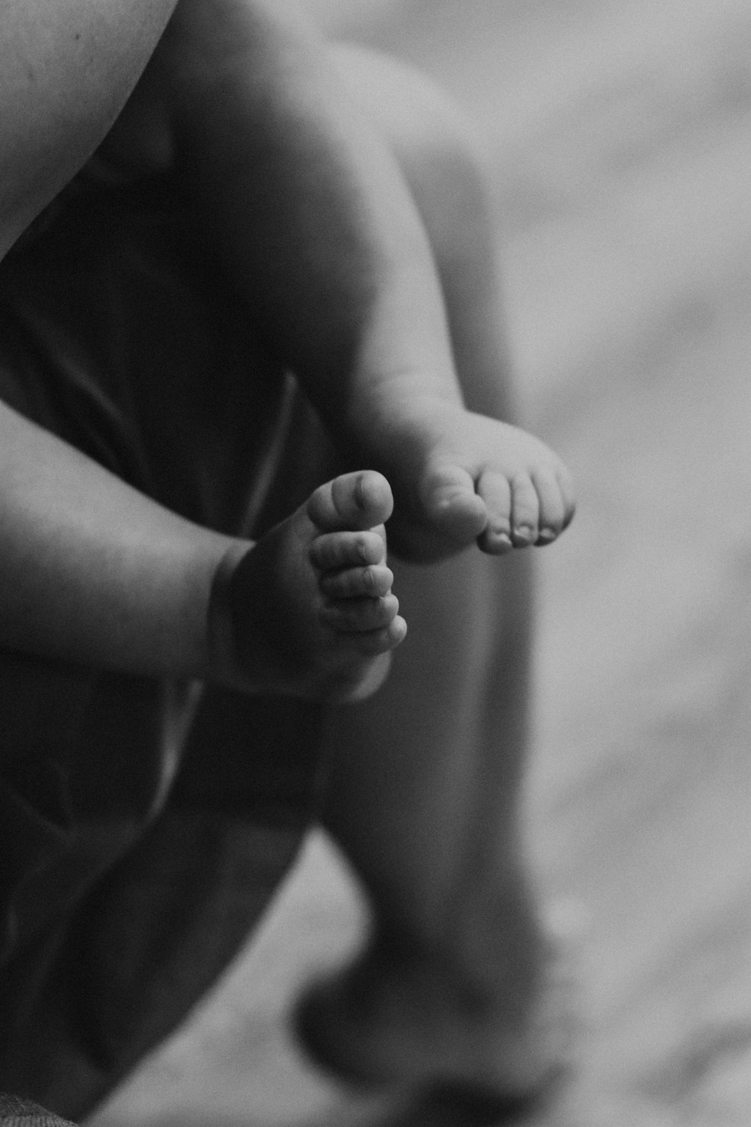 grayscale photo of babys feet