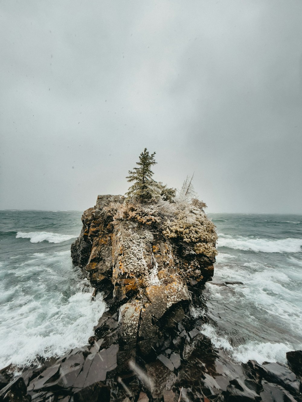 brown rock formation on sea during daytime