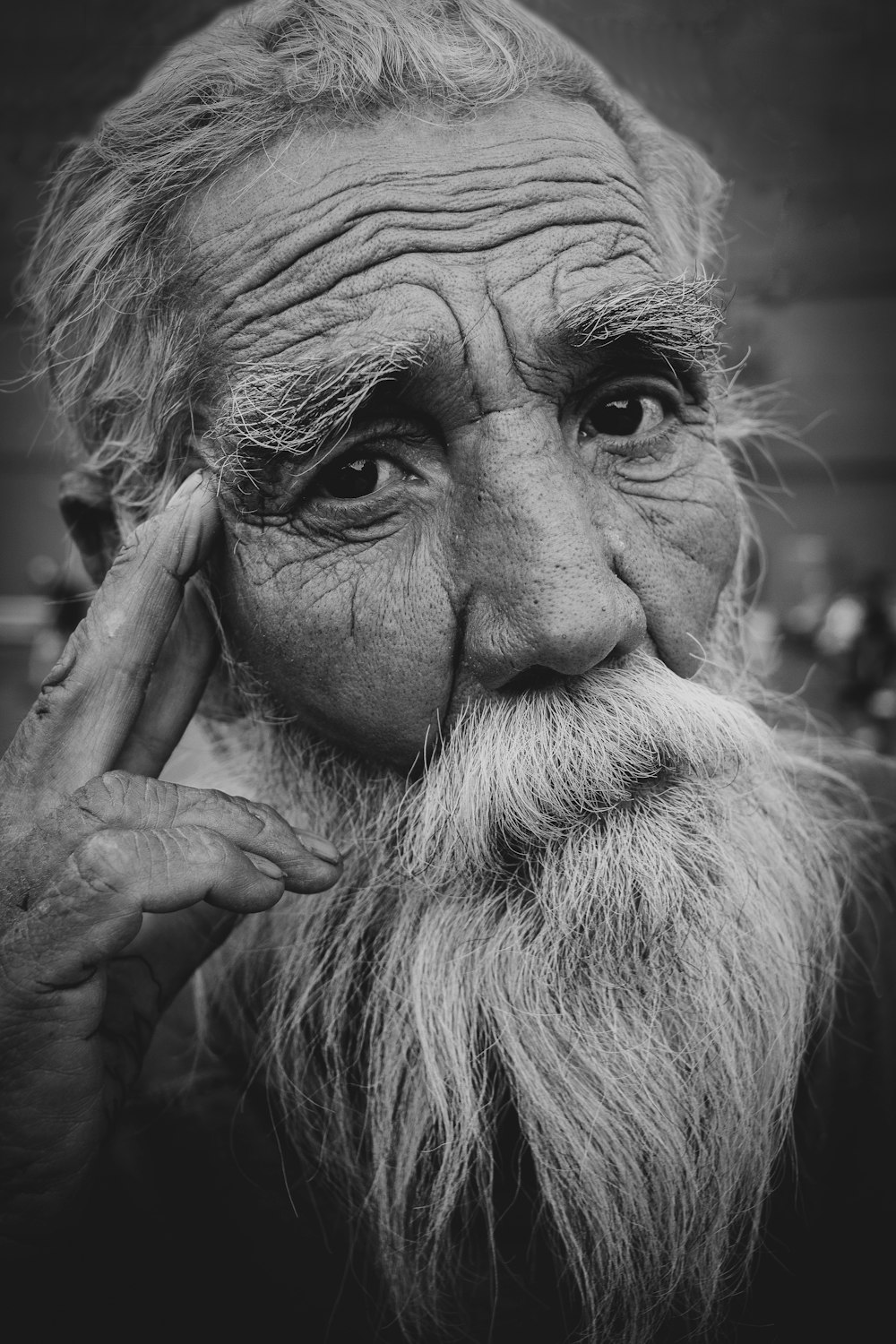 grayscale photo of man covering face with both hands