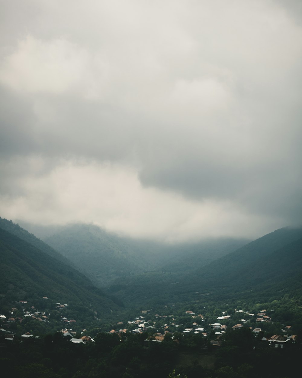 green mountains under white clouds