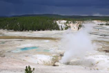 Geothermal energy installation with visible piping and green surroundings.