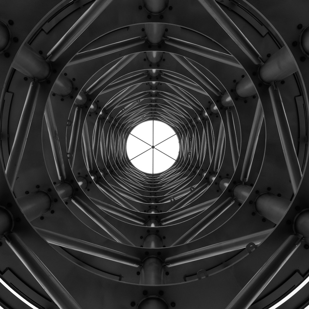 grayscale photo of tunnel with lights