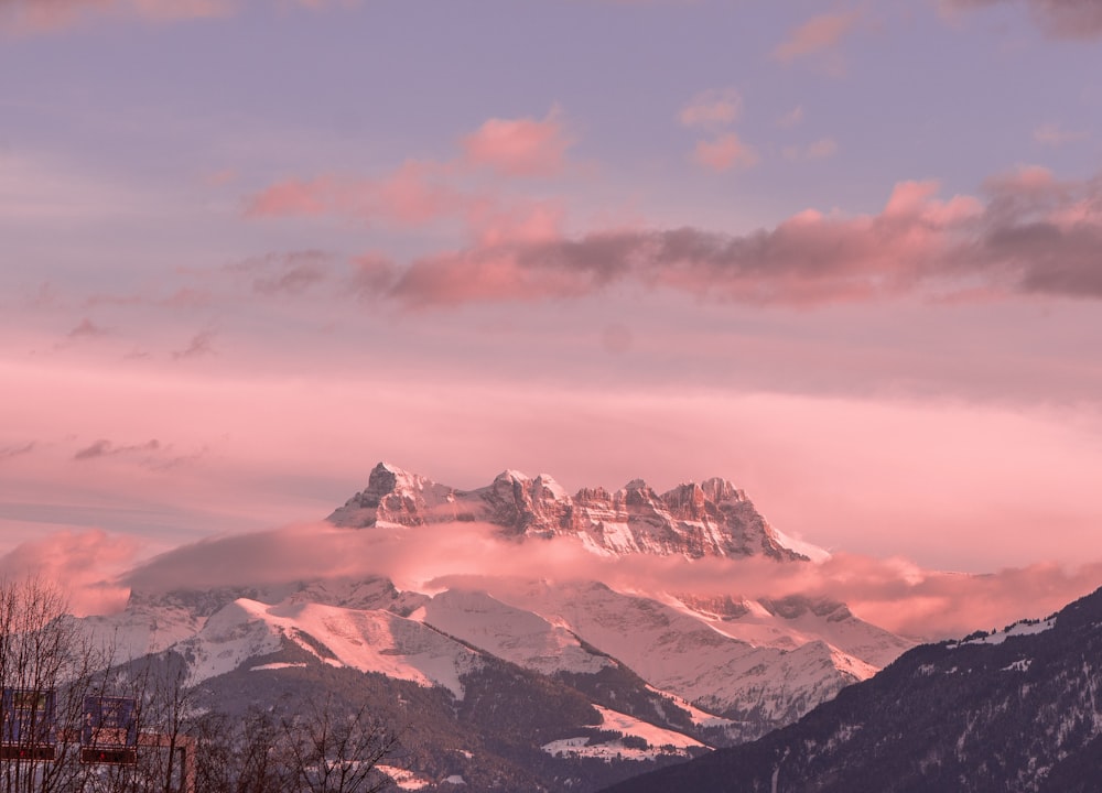 snow covered mountains under cloudy sky during daytime