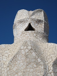 white concrete statue under blue sky during daytime