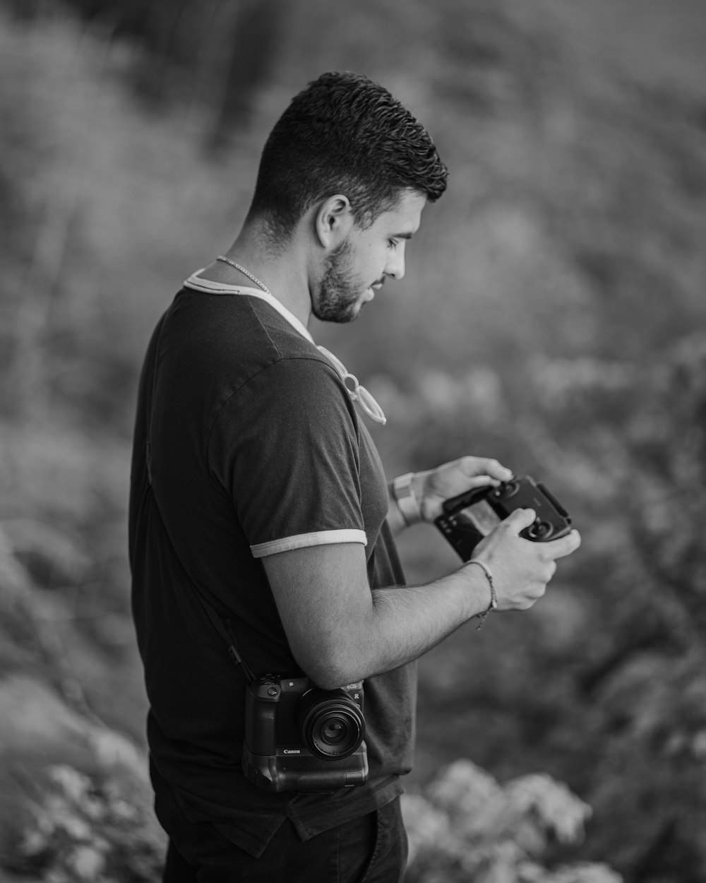 man in black t-shirt holding camera