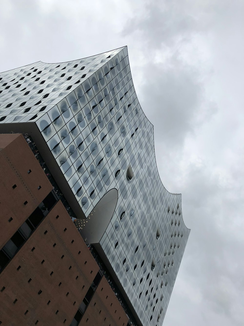 brown and white concrete building under white clouds during daytime