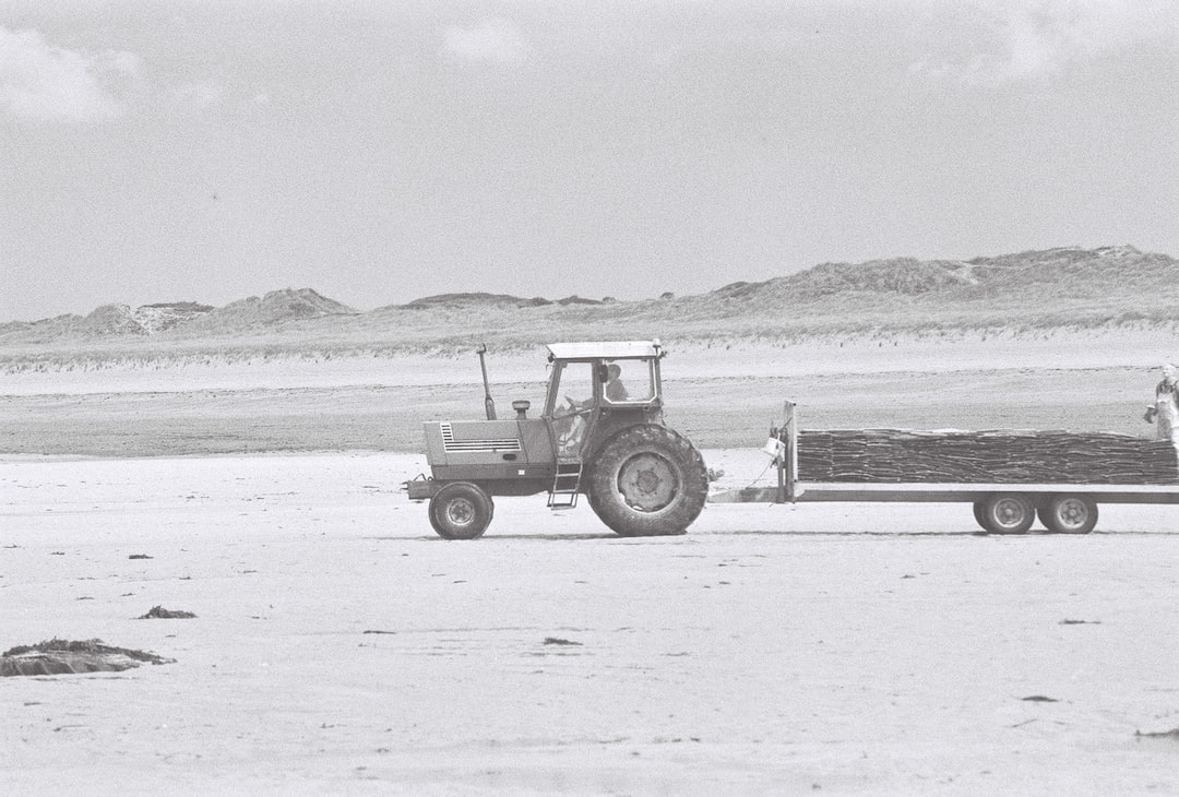 white tractor on white sand during daytime