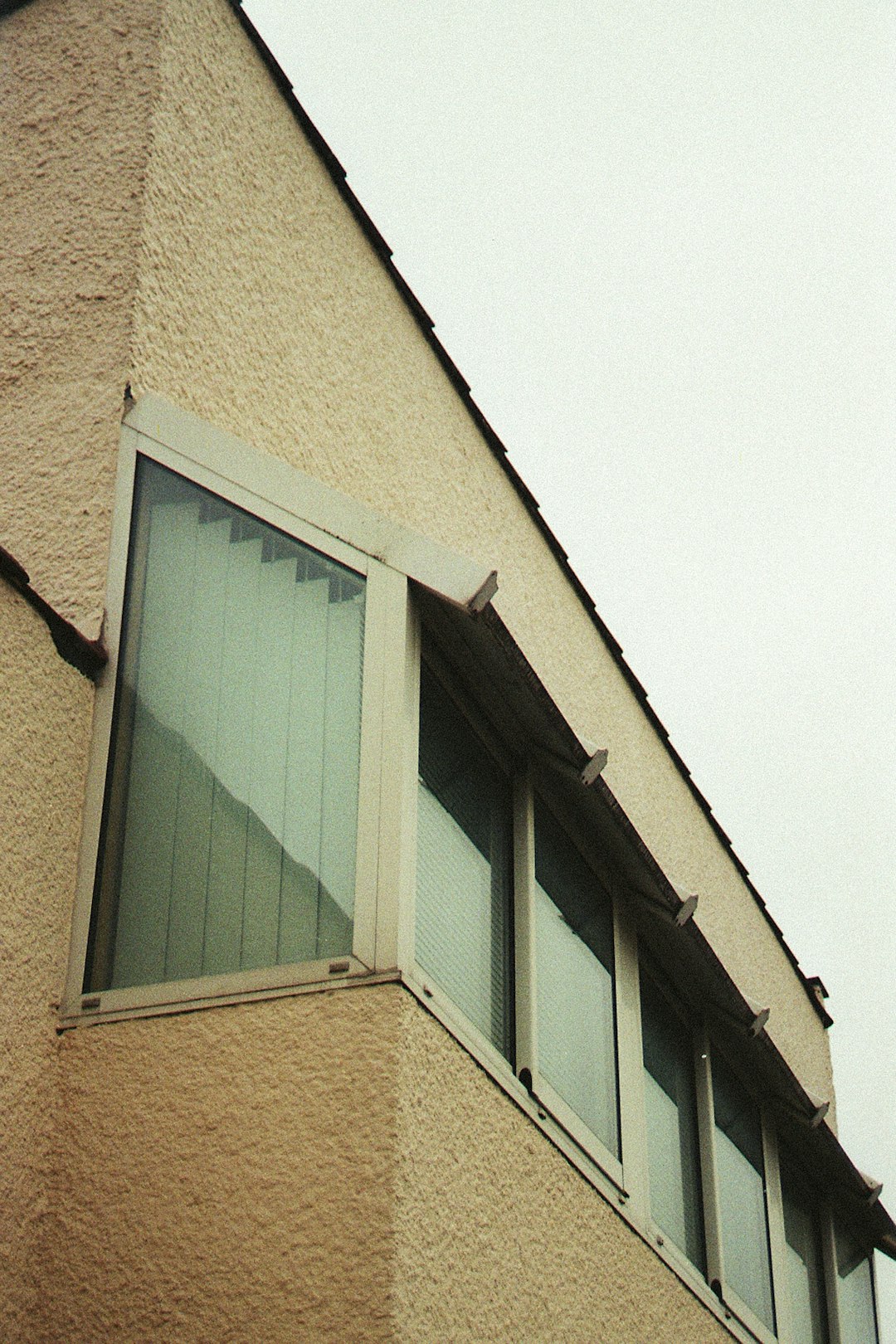 brown concrete building with green window