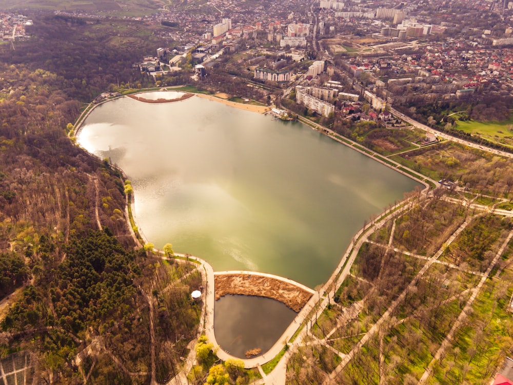 aerial view of lake between green trees during daytime