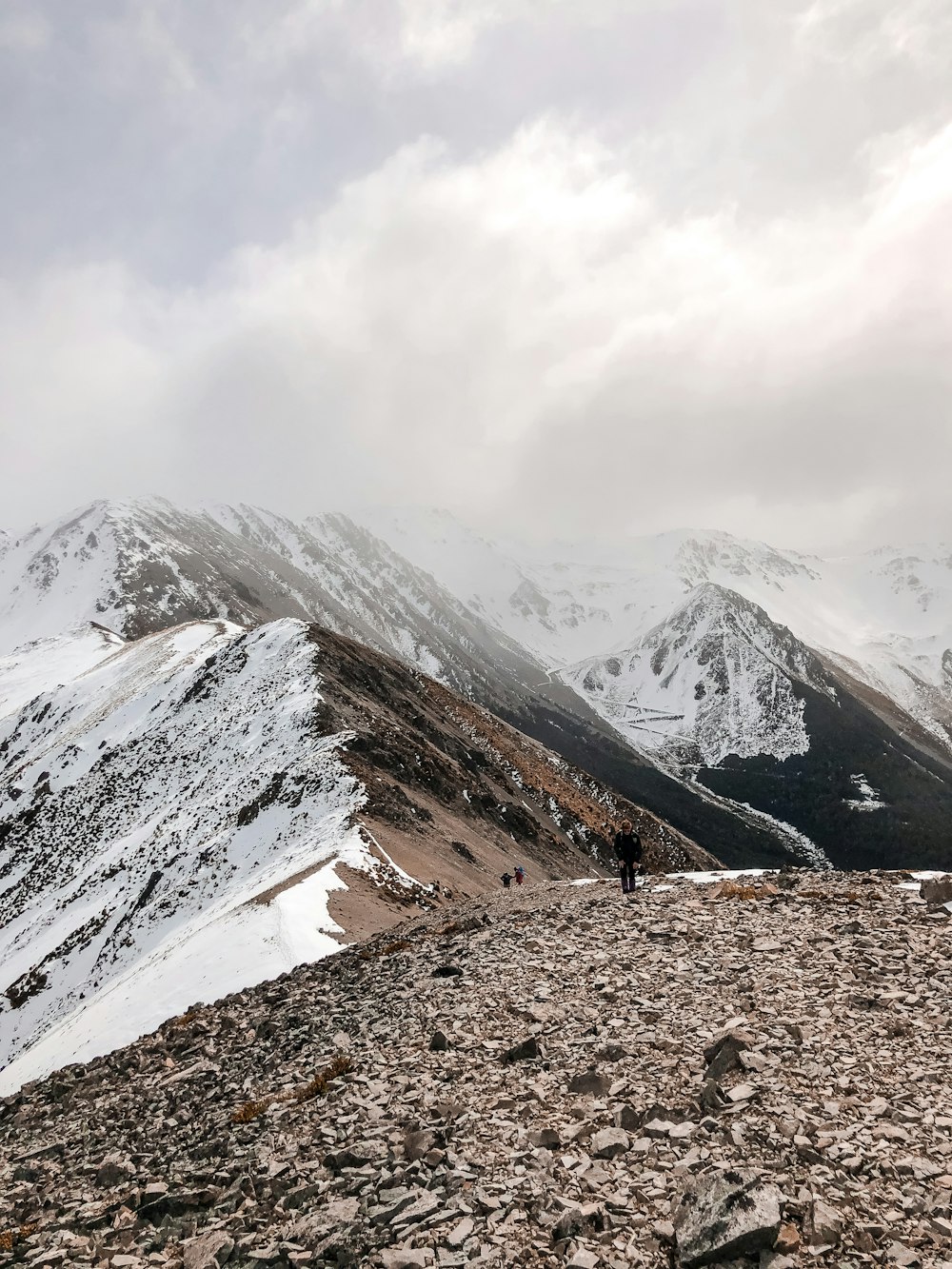 snow covered mountain under cloudy sky during daytime