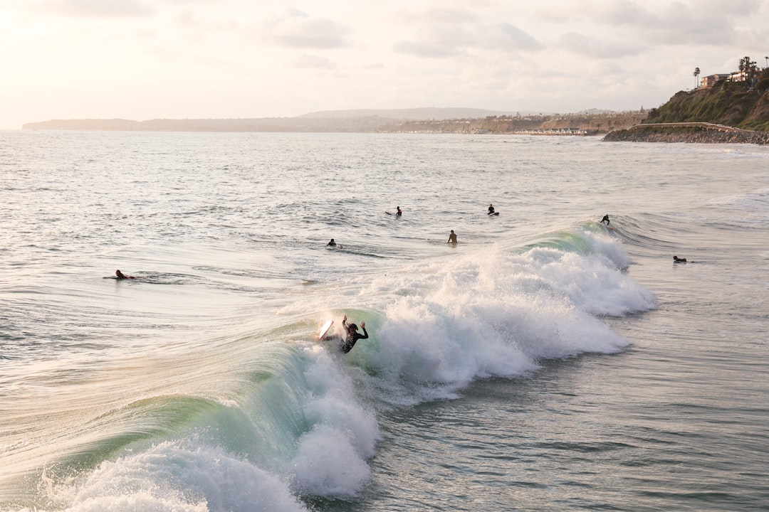 people surfing on sea waves during daytime