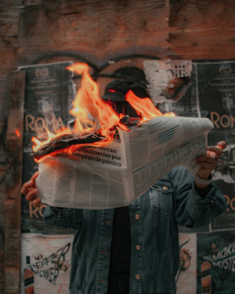 man in black jacket holding newspaper