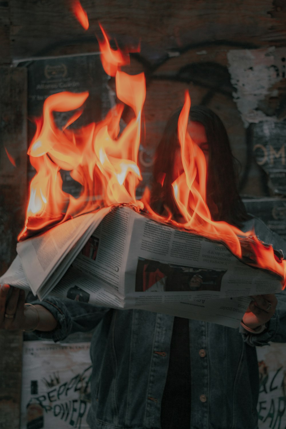 fire in front of gray concrete wall