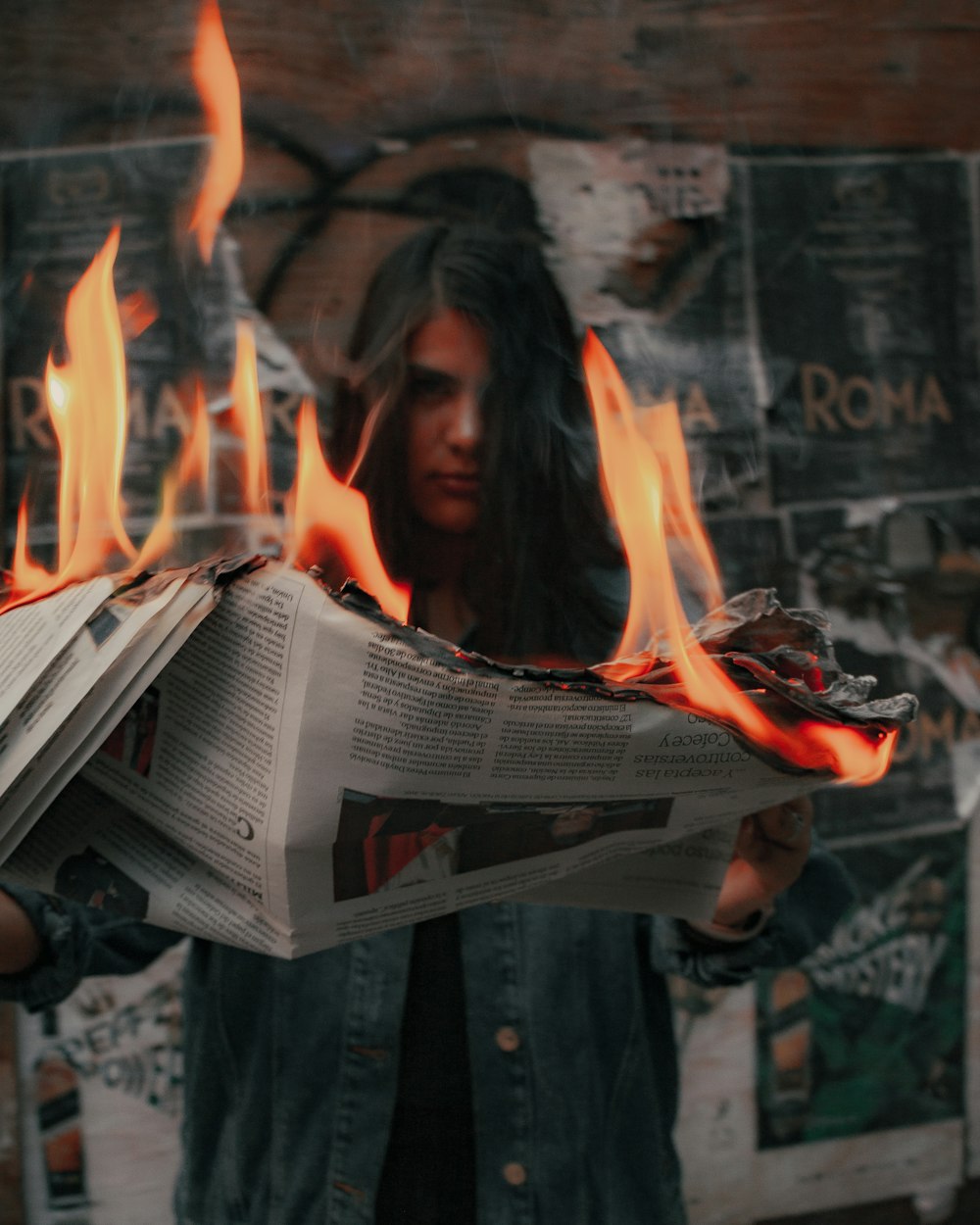 woman in black jacket holding newspaper