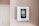 A digital thermostat is mounted on a beige wall. The thermostat has an LED screen displaying the temperature settings and controls below it. The overall look is clean and minimalistic.