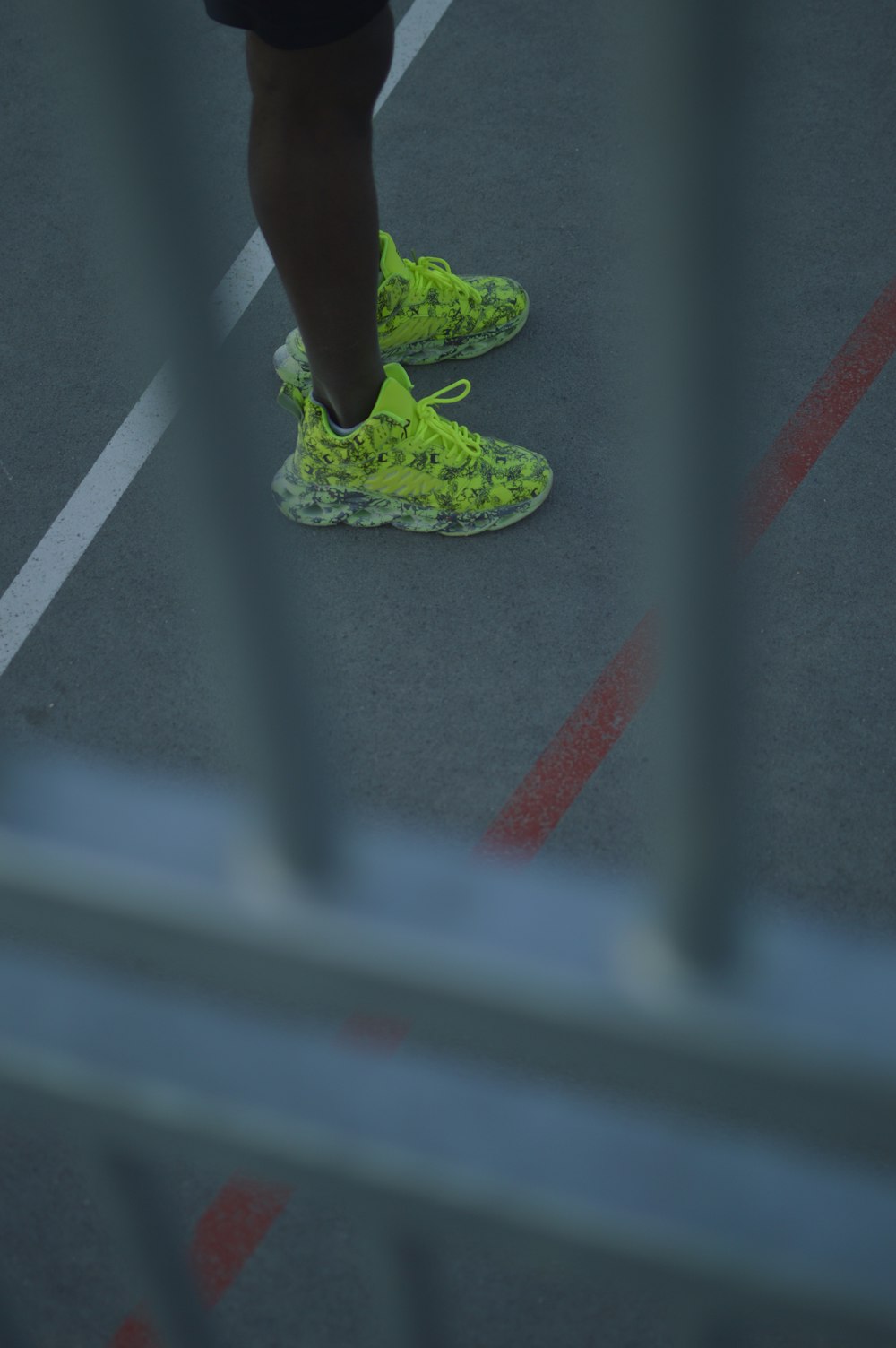 person in green nike athletic shoes