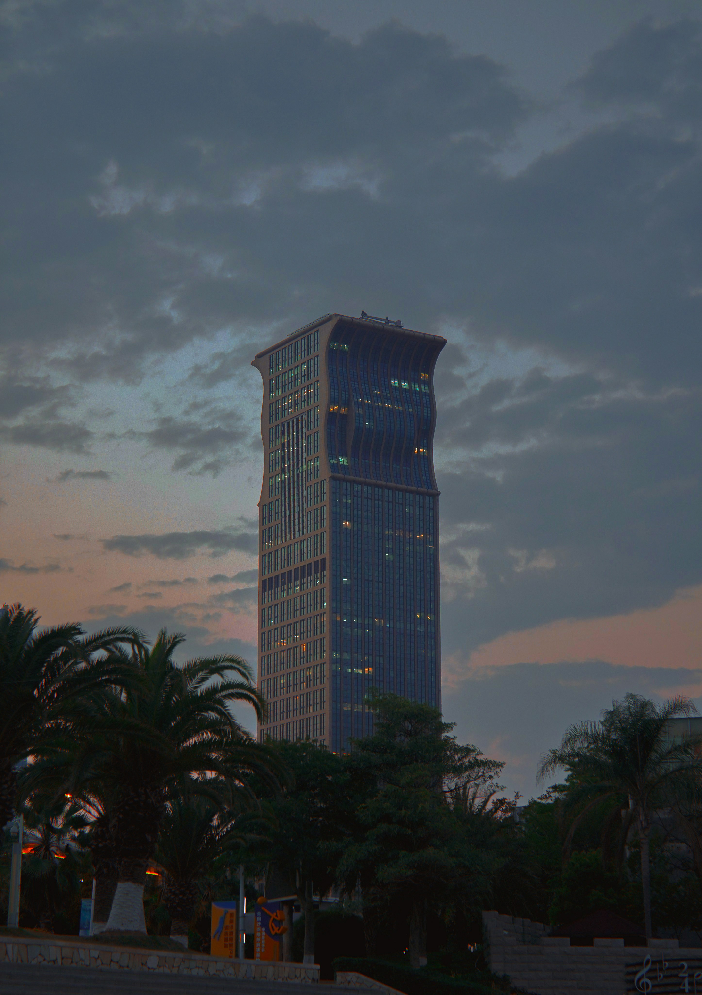 green palm trees near high rise building during daytime