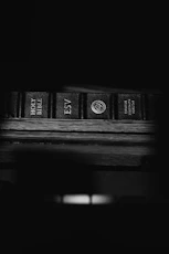 black and brown books on brown wooden table