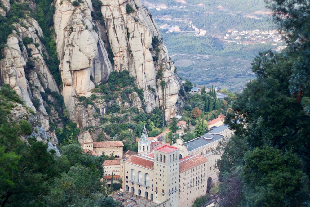 white and brown concrete building on top of mountain during daytime