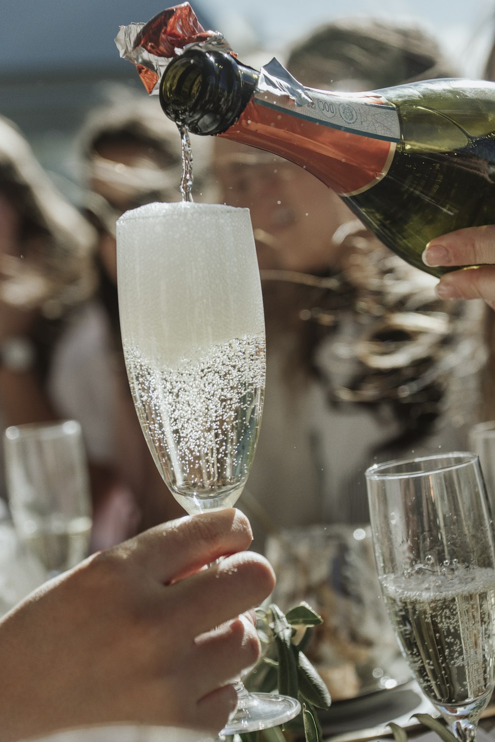 person holding clear wine glass