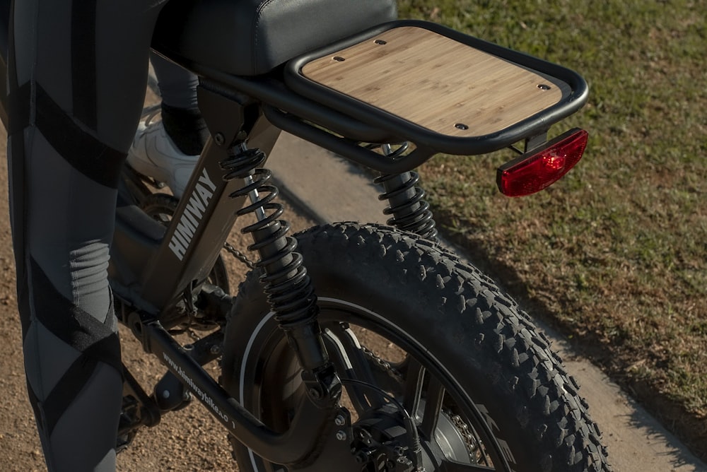 black motorcycle near brown wooden bench