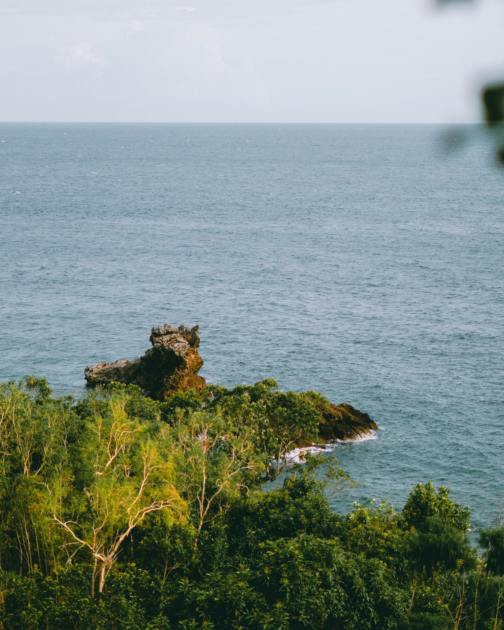 brown rock formation on sea during daytime