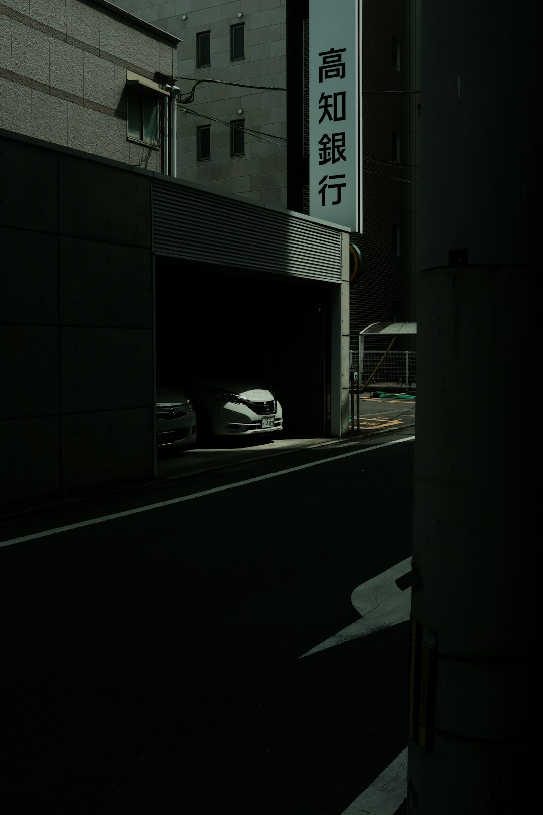 white car parked beside building