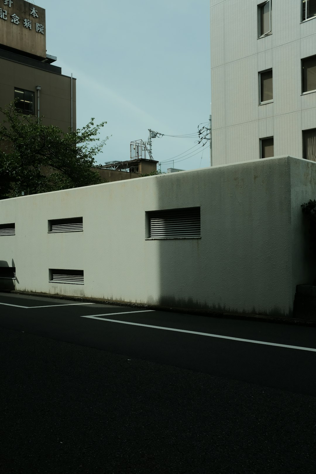 white concrete building near green trees during daytime