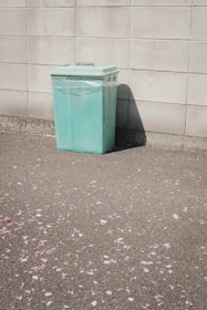 Close-up of sparkling clean trash bin with mist of fresh aroma in a green backyard.