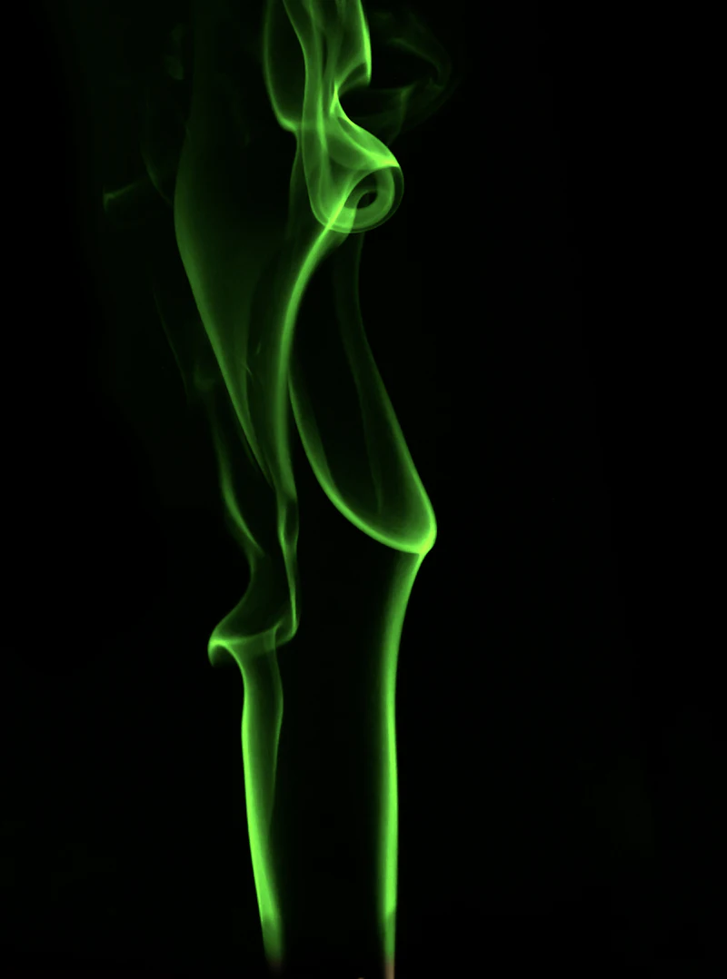 Luminous green energy billowing against darkness, like Exotic Matter venting from a portal