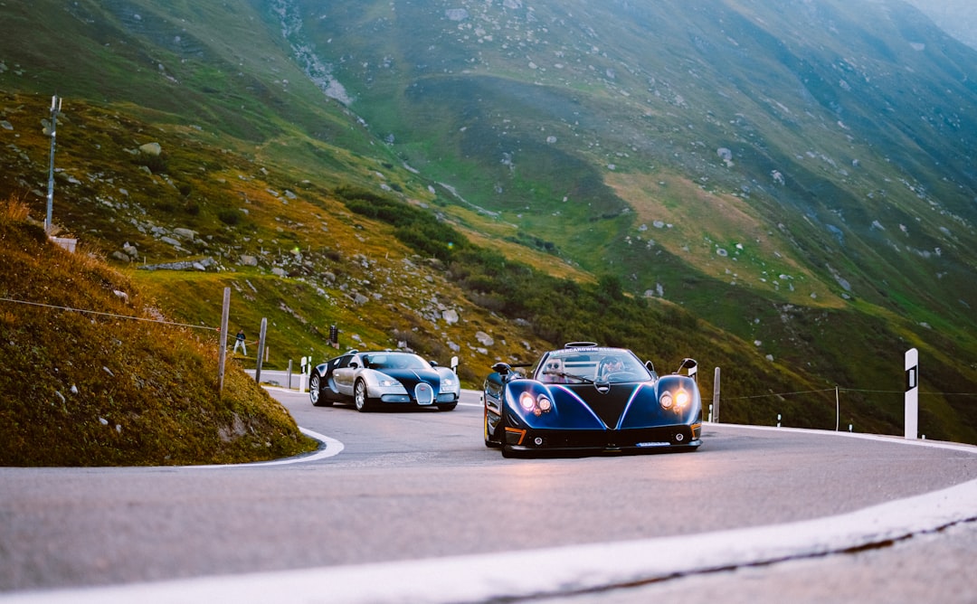 blue car on road near mountain during daytime