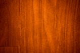 Close-up of rich, natural wood siding with visible grain and warm tones.