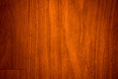 Close-up of rich, natural wood siding with visible grain and warm tones.