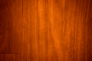 Close-up of smooth walnut wood grain with warm brown tones