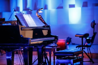 Elegant grand piano on a stage bathed in soft blue and white lighting, reflecting the festival's classic and modern style.