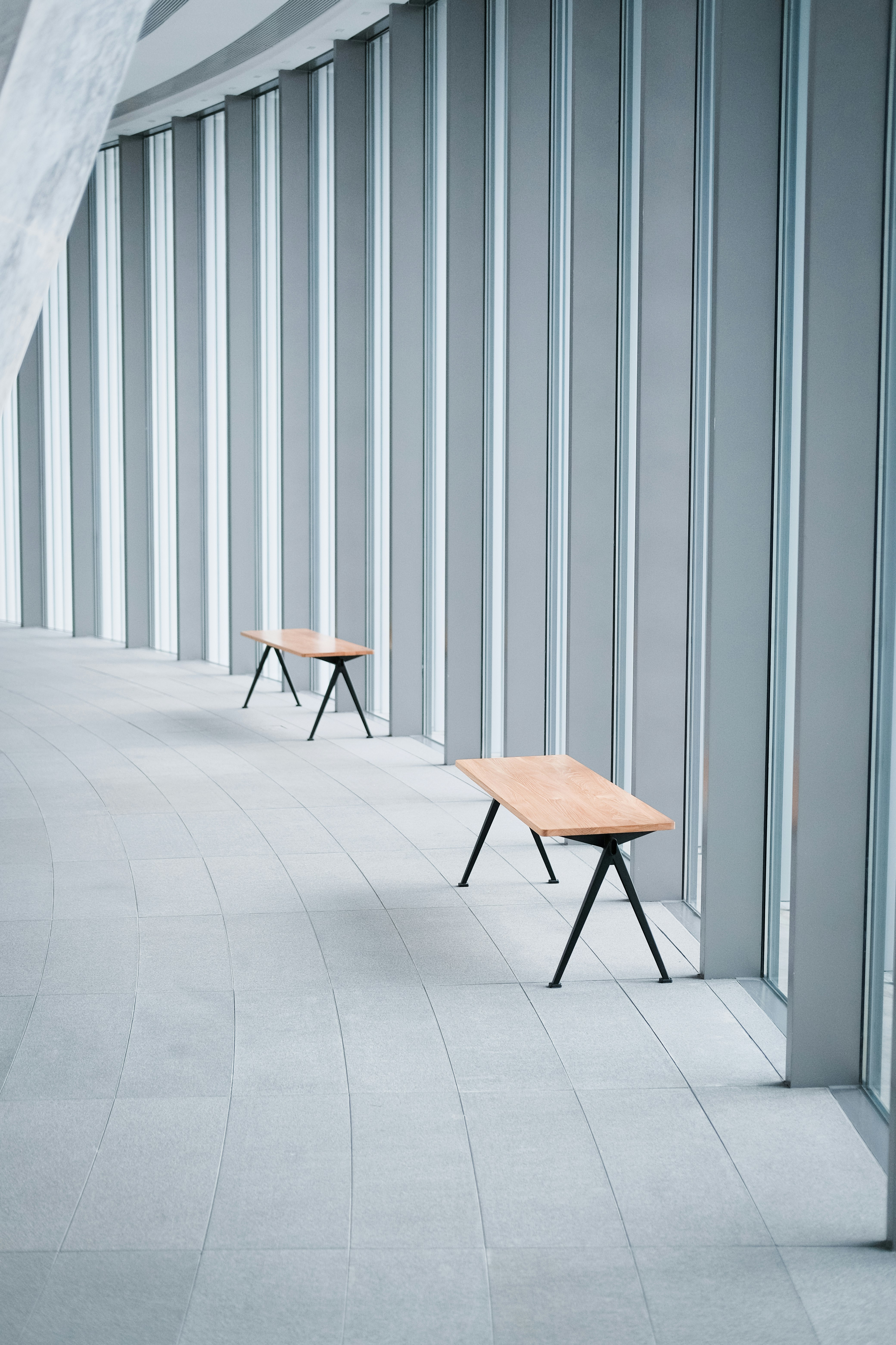 brown wooden chair beside gray wall