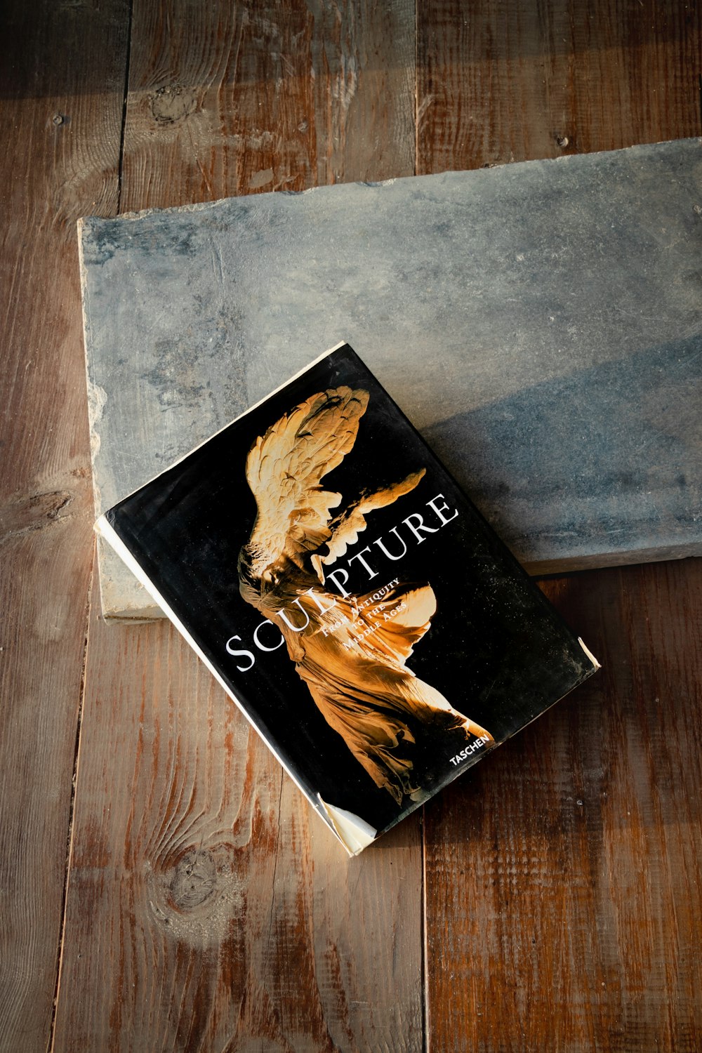 black and brown book on brown wooden table