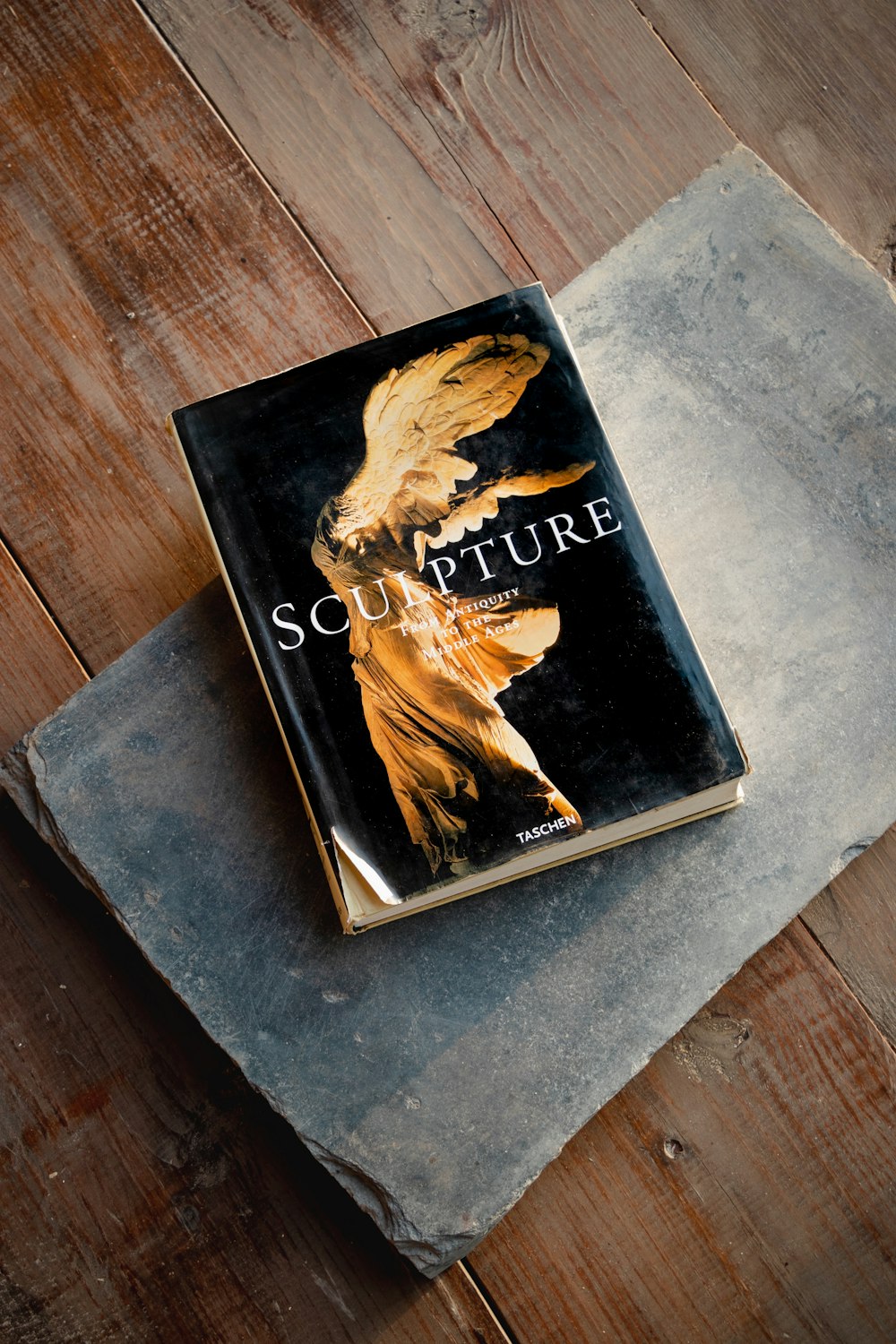 black and brown book on brown wooden table