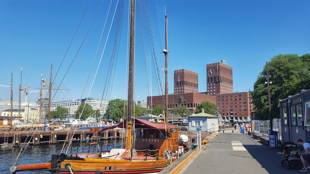 brown and white boat on dock during daytime