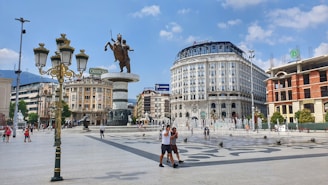 people walking on park near white concrete building during daytime