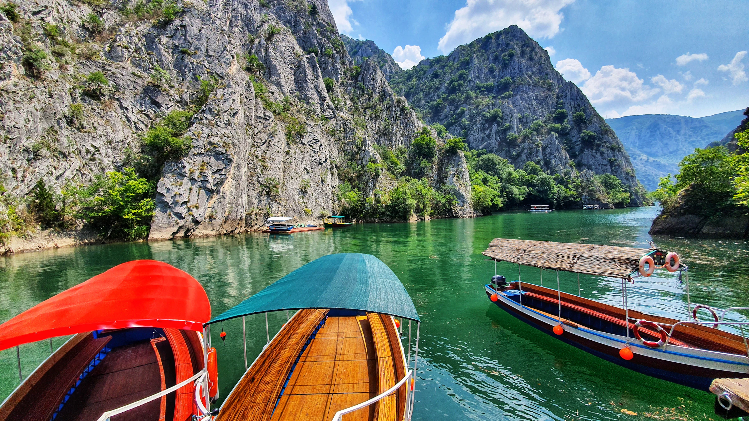 Wooden boats on the emerald water of Matka Canyon