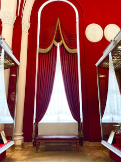 A deep crimson wall with framed charts and trading notes, creating a cozy yet professional atmosphere.